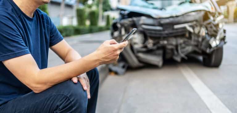 man texting lawyer after a car accident