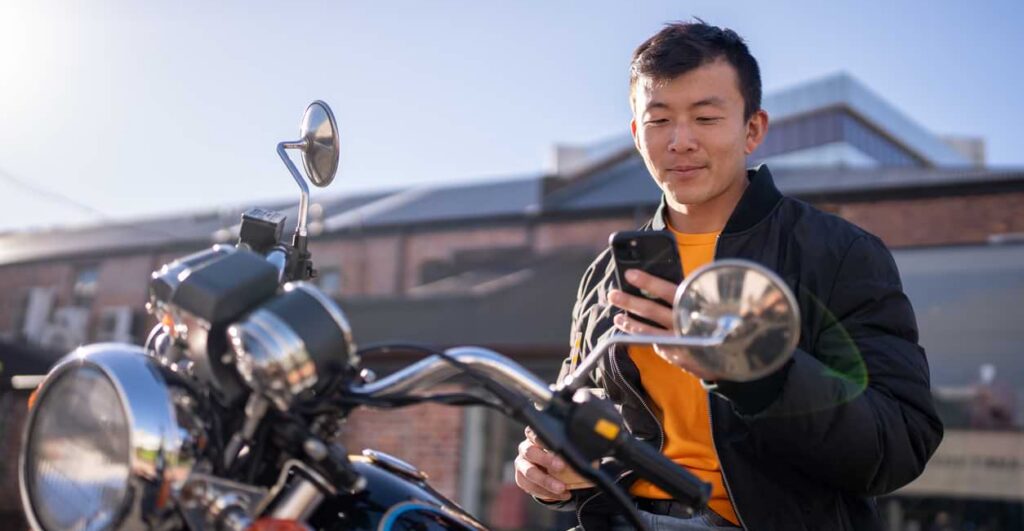 motorcyclist looking up legal information on phone