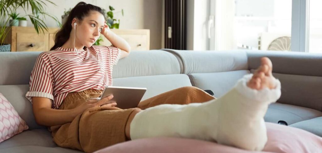woman with broken leg in cast recovering after an accident